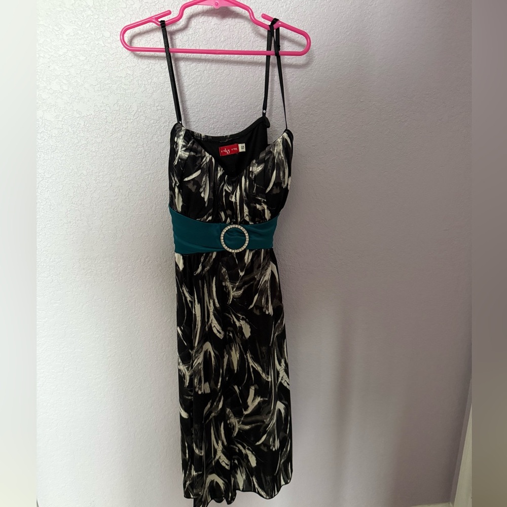 Black/grey/white midi dress with teal bow.